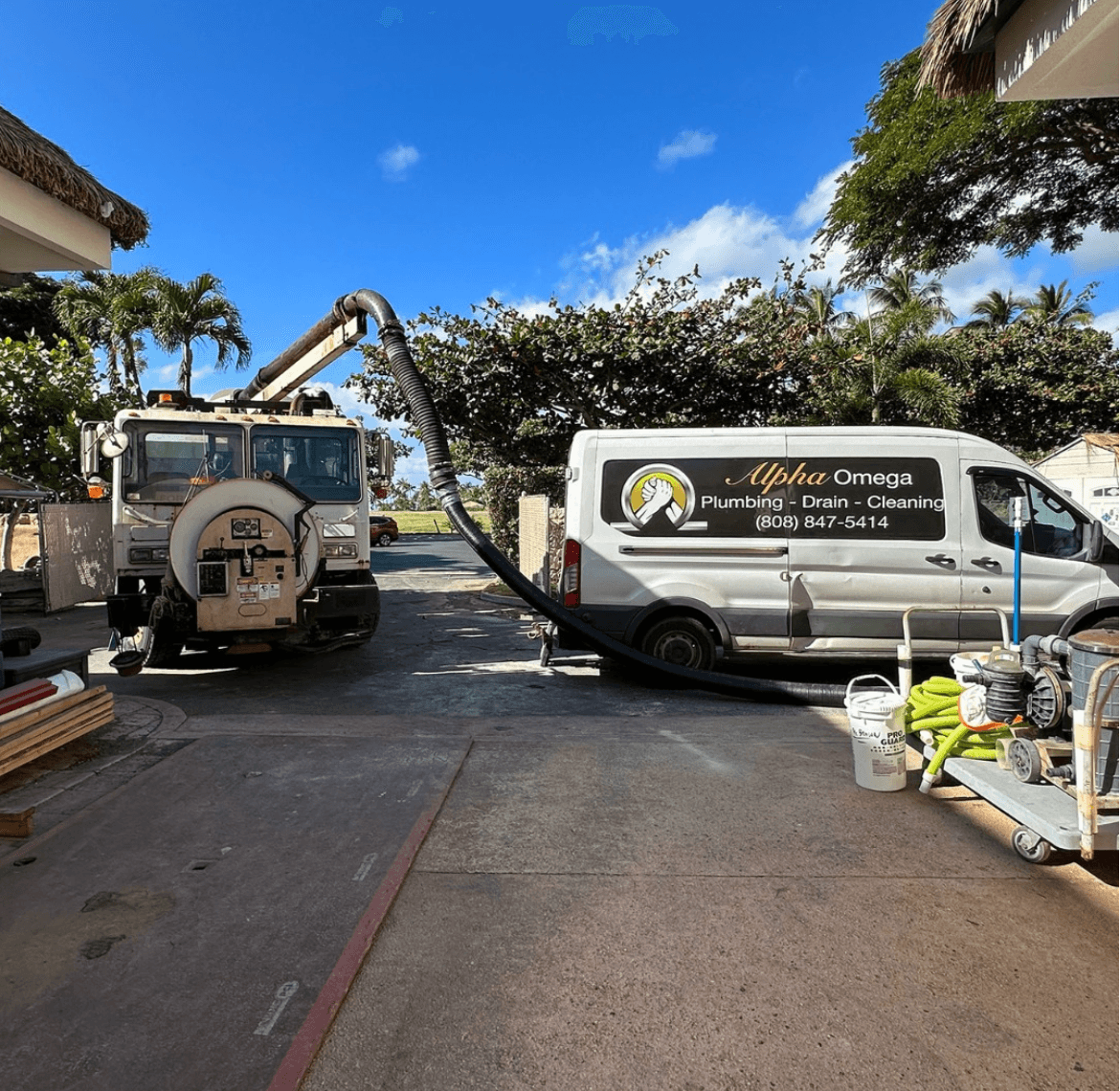 Alpha Omega Plumbing van and equipment on an O'ahu job site