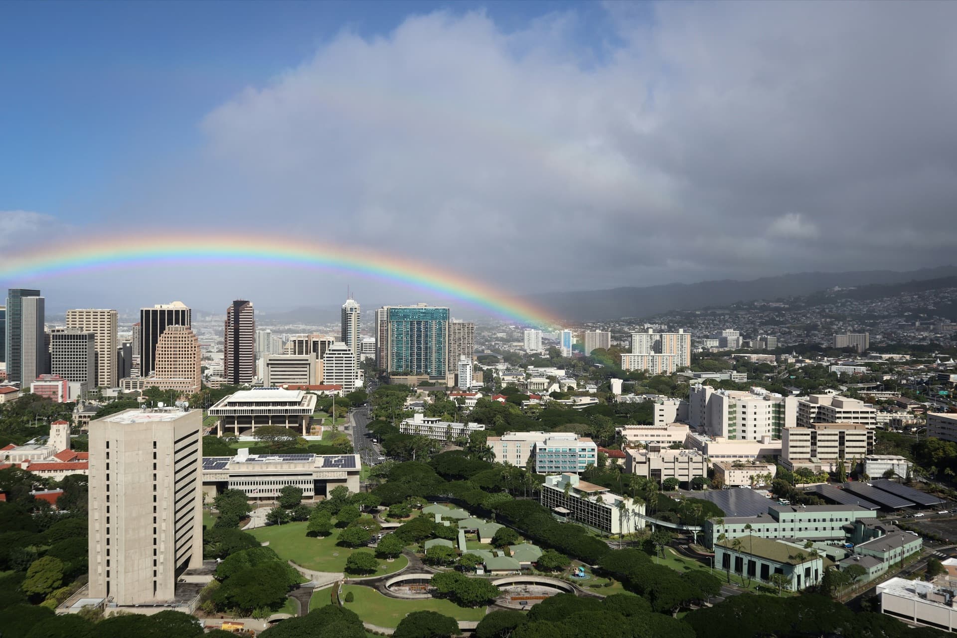 Aerial view of Honolulu and O'ahu under a rainbow, where smart water habits cut household bills — Alpha Omega Plumbing